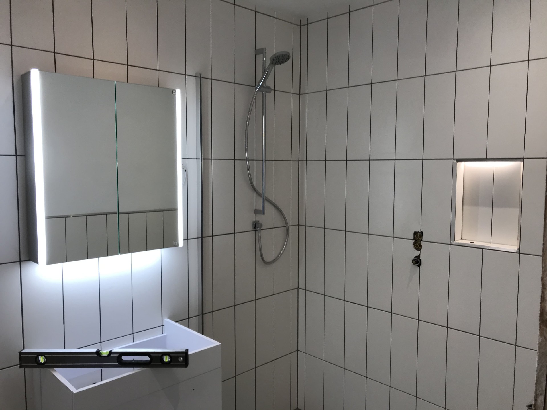 Completed bathroom interior with finished tiling and fitted fixtures