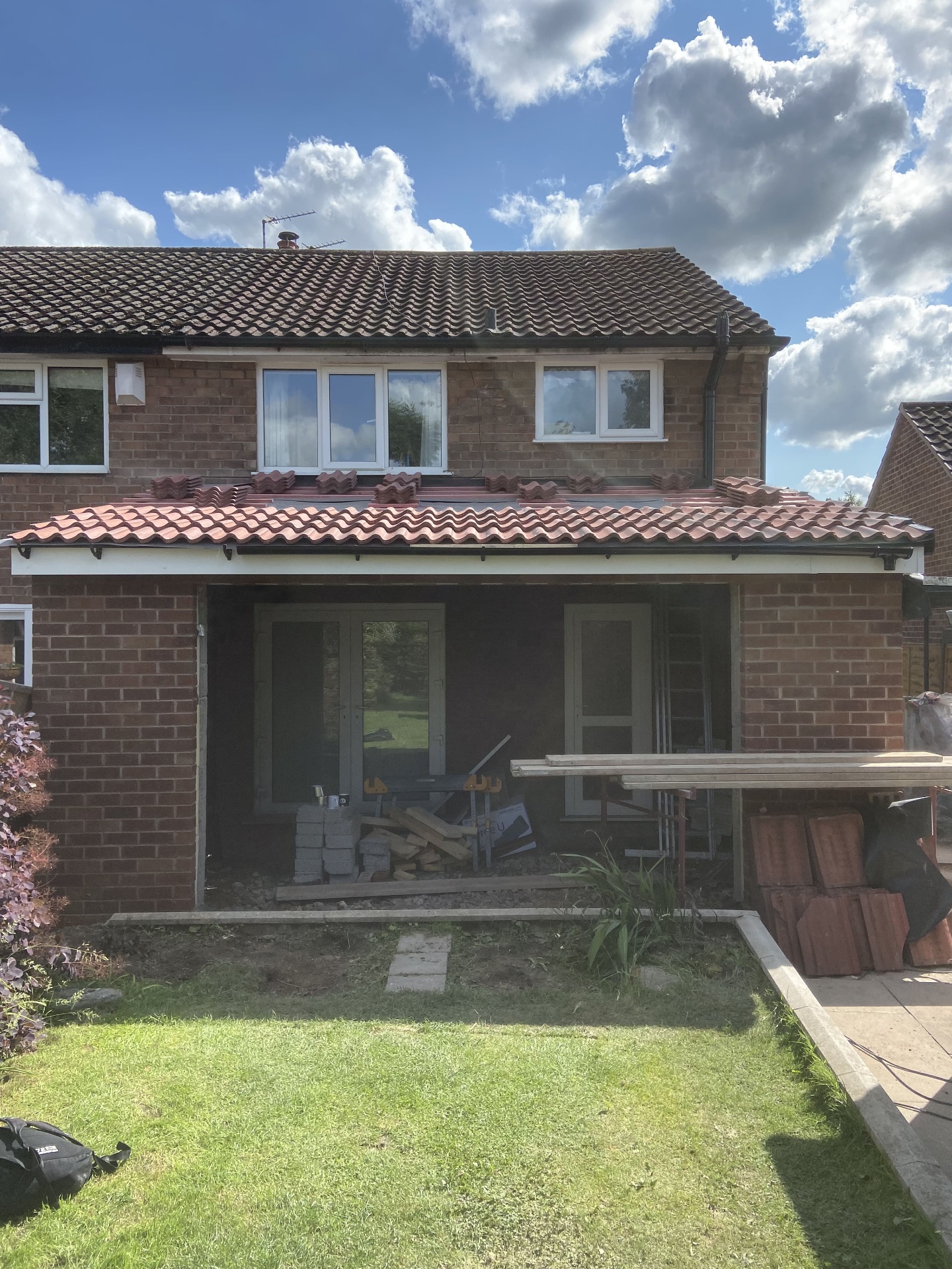 Rear extension brick shell under construction with wide structural opening