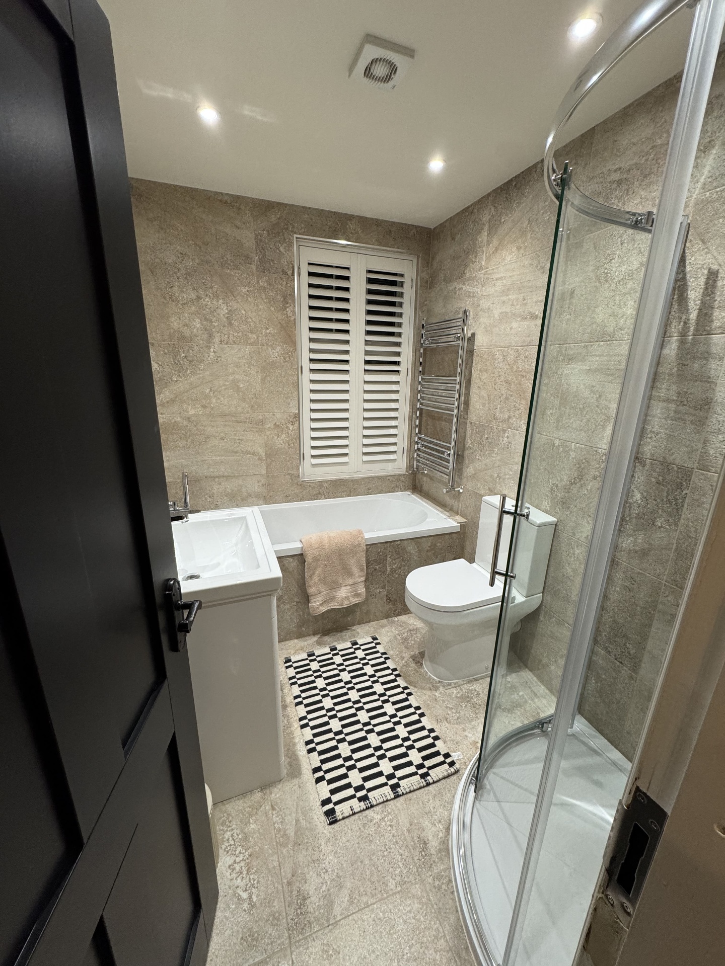 Completed bathroom with walk-in shower and contemporary fittings
