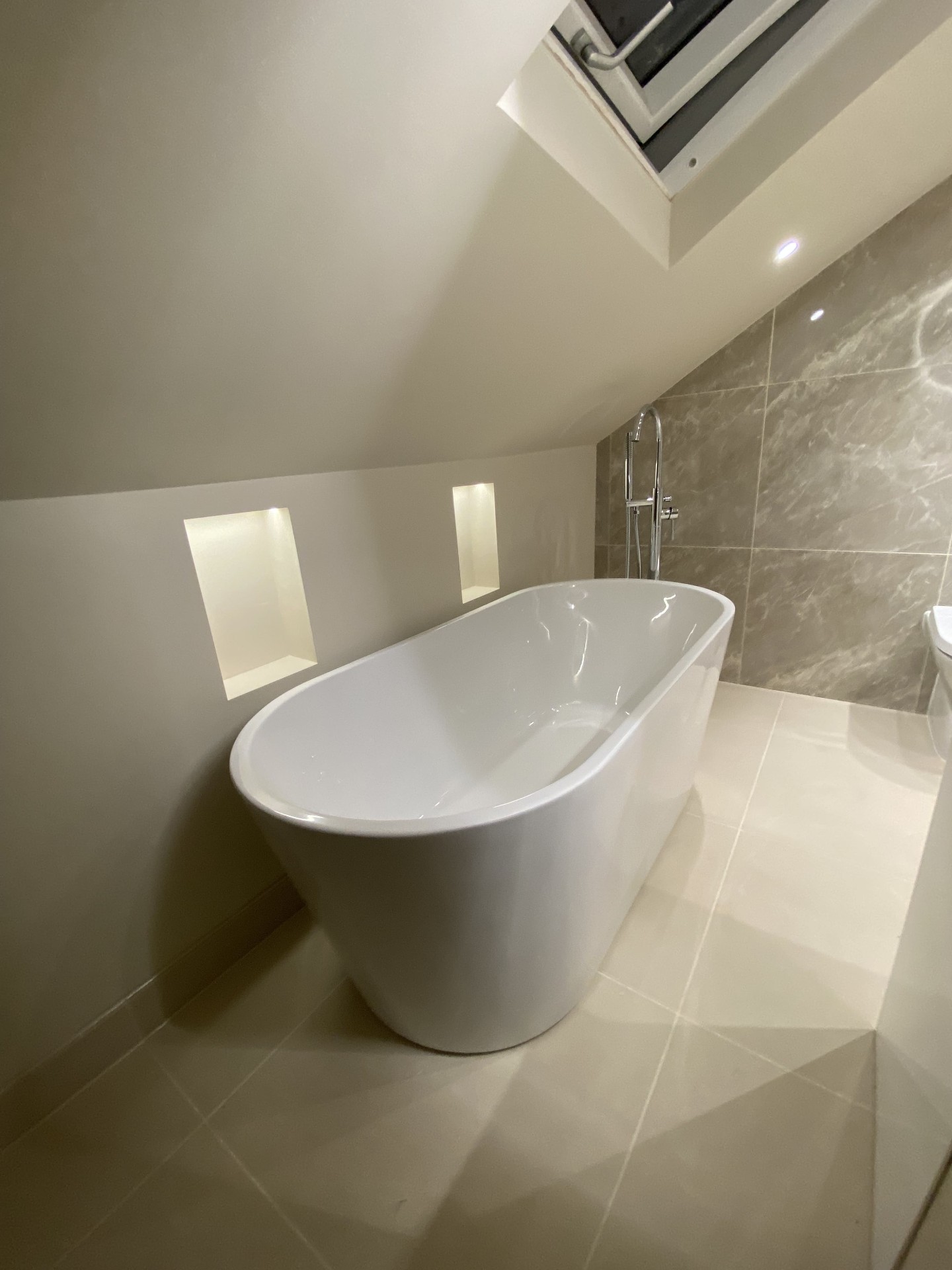 Completed bathroom wall tiling and fixture detail