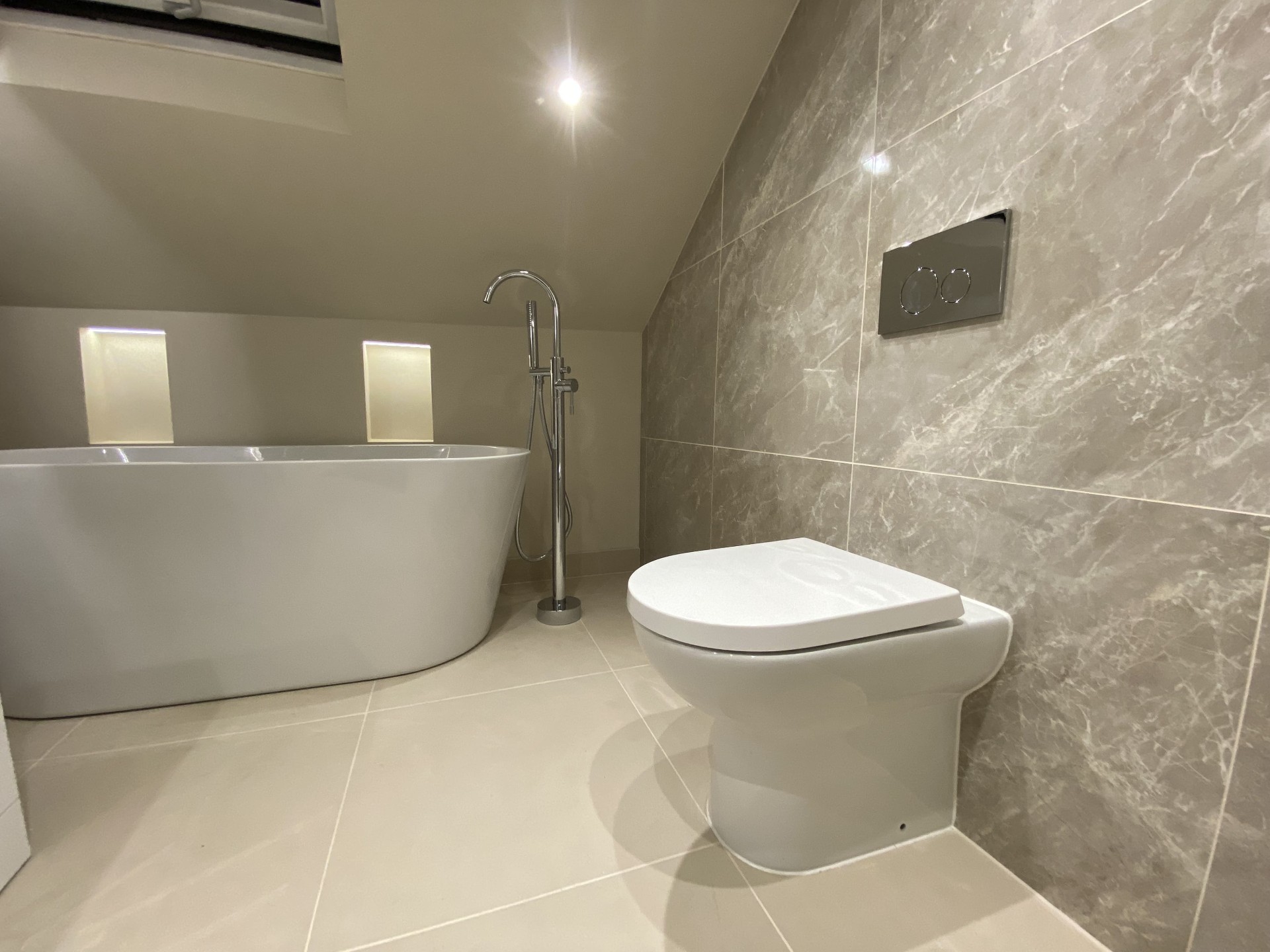 Completed shower room with clean-lined modern tiling