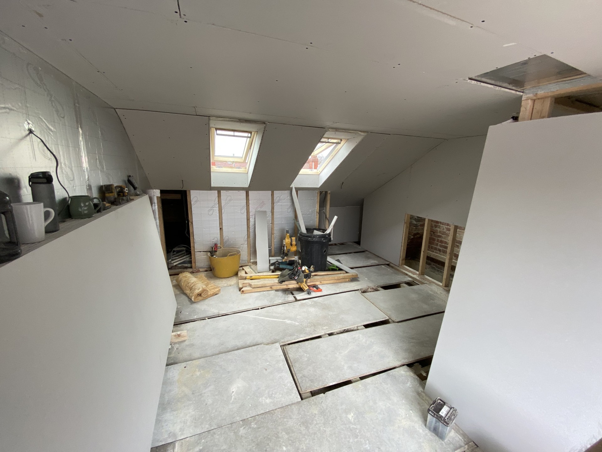 Loft interior boarded and plastered at first-fix stage before completion