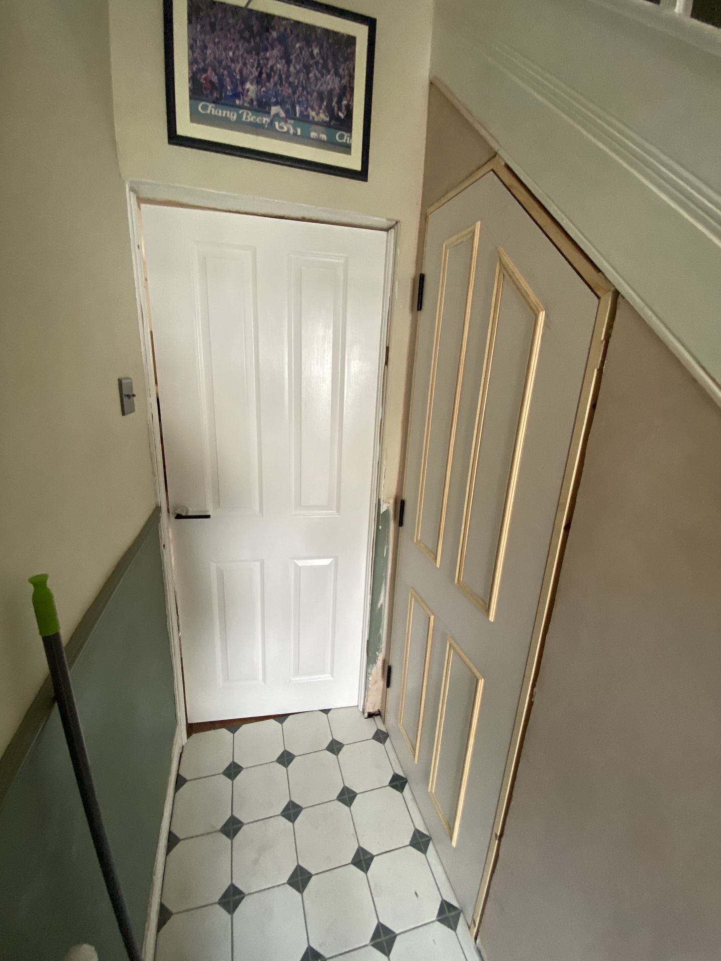 Completed hallway with fresh paintwork, refurbished doors and tiled flooring
