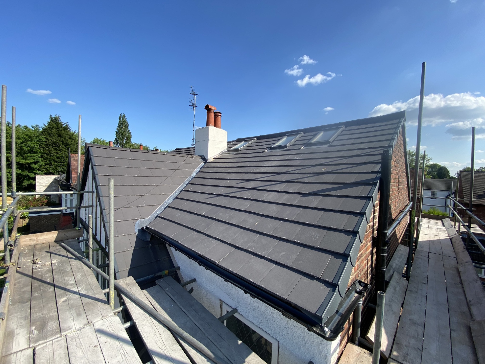 Completed tiled roof with integrated rooflights and new rainwater goods