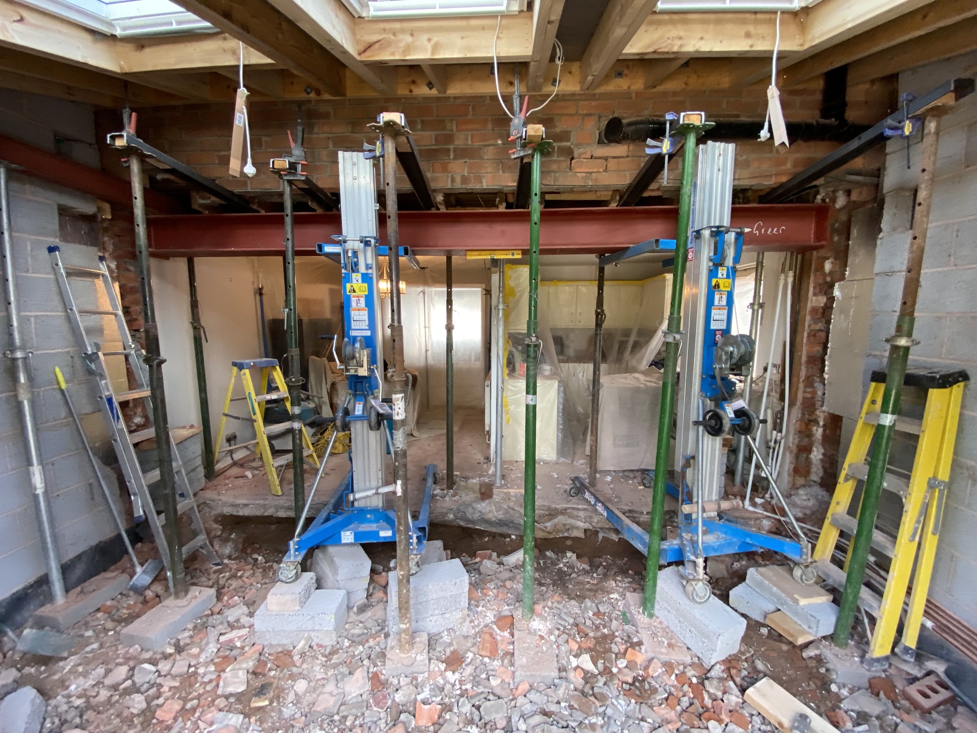 Structural steel installation beneath new rooflights during a major extension build