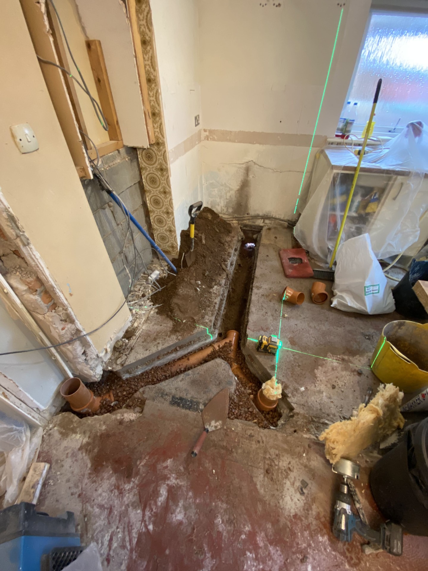 First-fix drainage trench being formed through an existing floor during renovation works