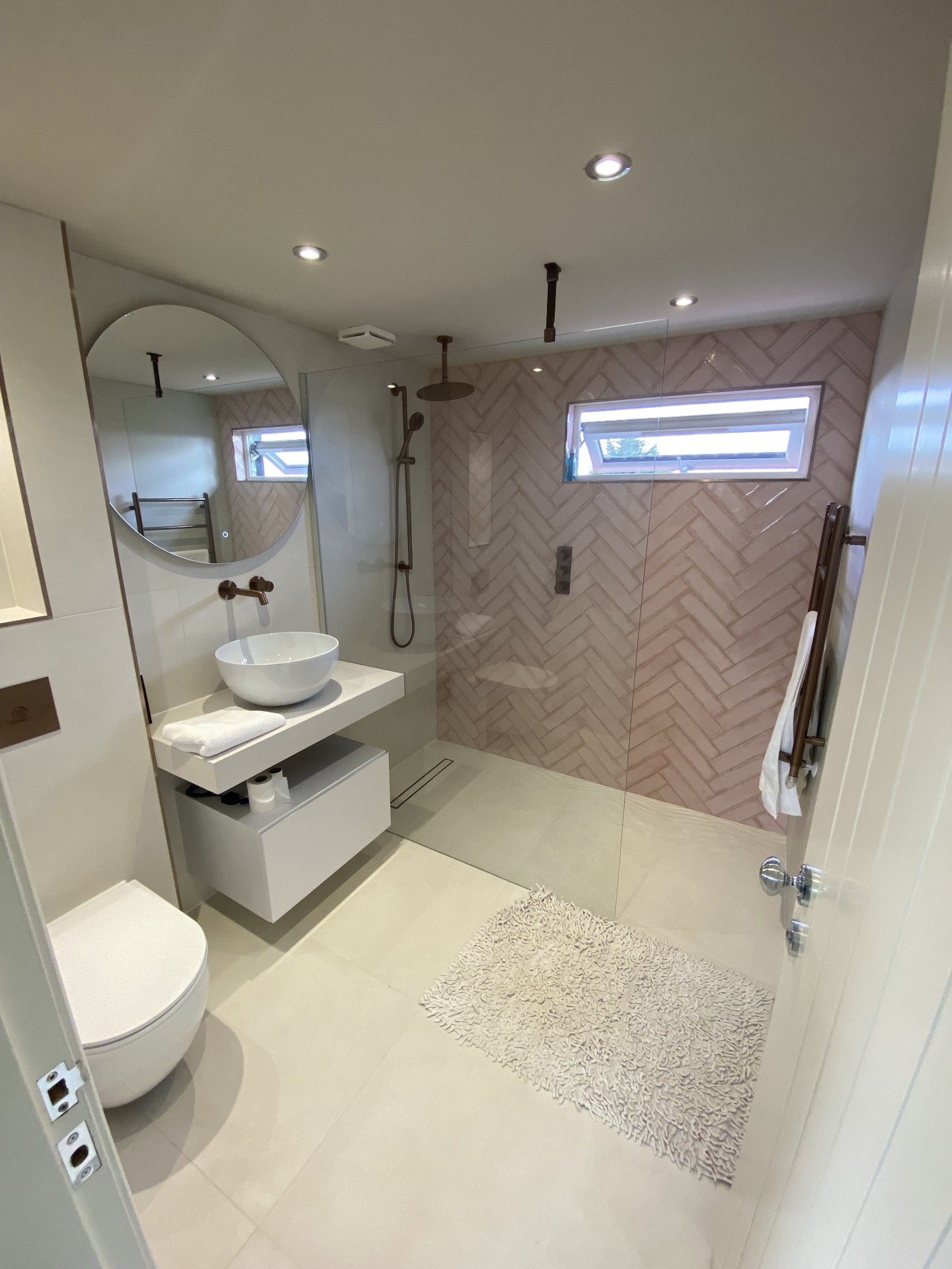 Completed bathroom with fitted vanity and contemporary wall tiling