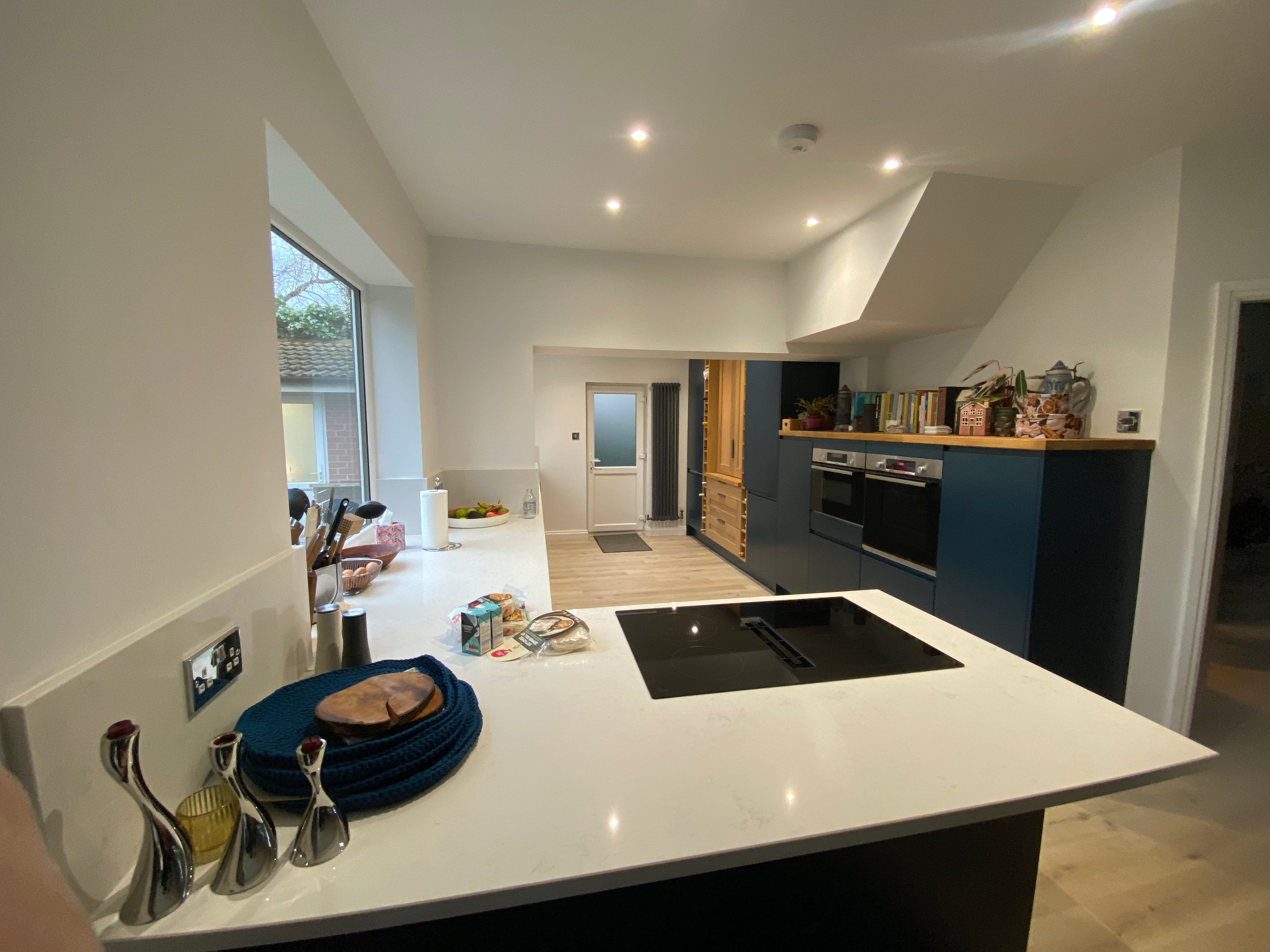 Finished open-plan kitchen and dining space with wide garden glazing