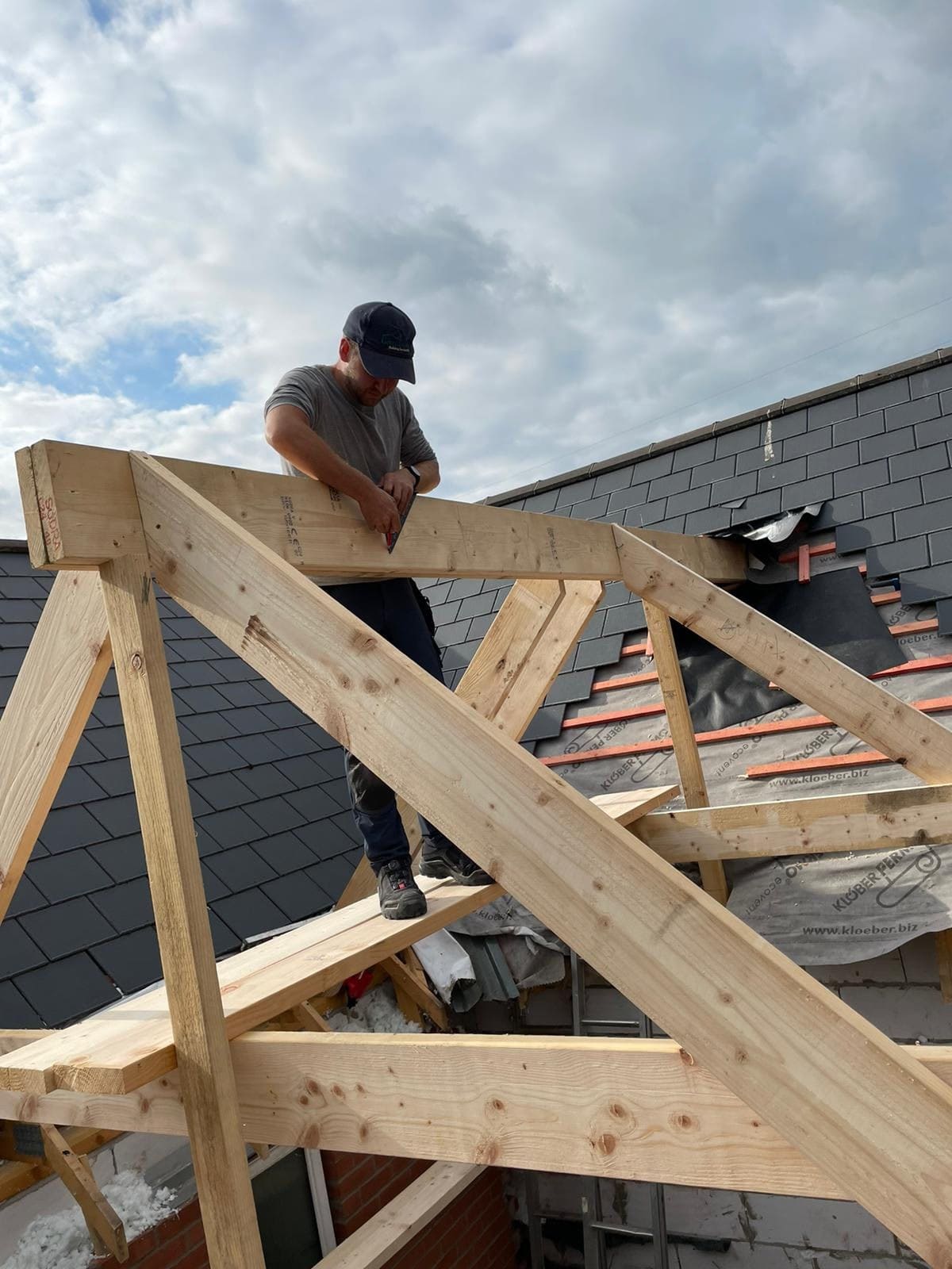 Greenbank carpenter framing a new pitched roof structure over freshly slated dormer work